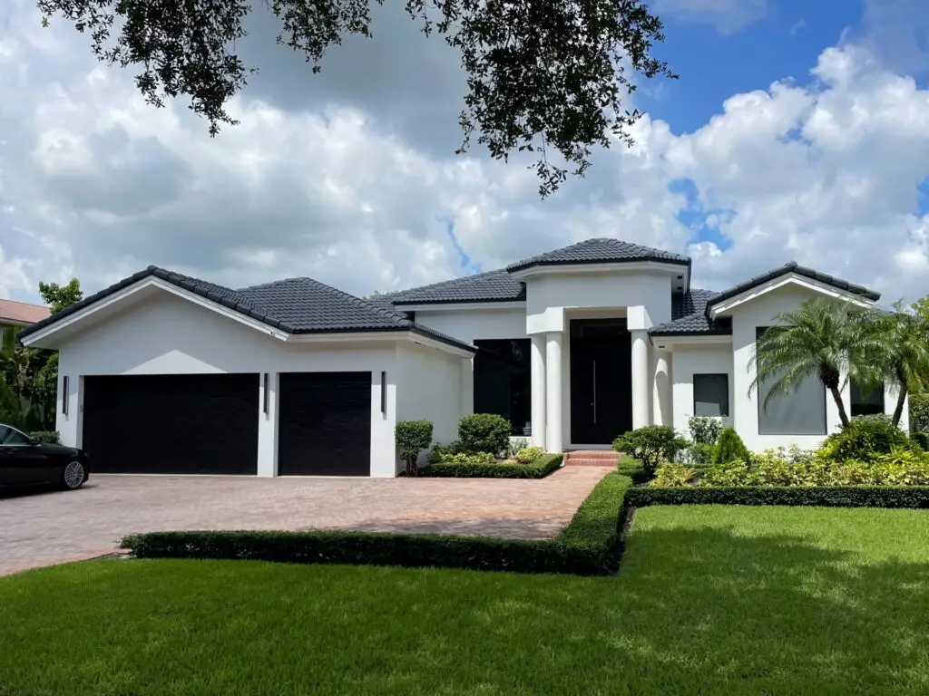 Front Modern Home updated with large format impact glass and large entry pivot door