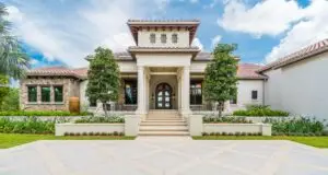 Front Entry with Doric Stone Columns and Colored Concrete Drive