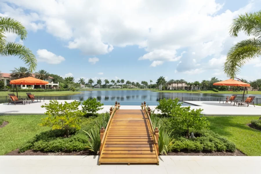 Arched wooden bridge to pool and pool deck