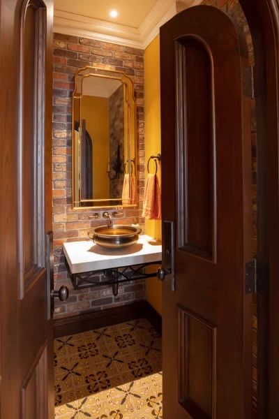 Power Room with Bi-Parting Entry Door and Vessel Sink on Natural Stone Top and Painted Tile Floor