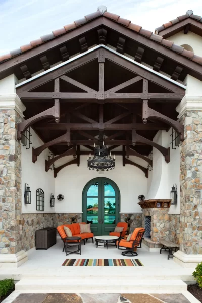 Rear Loggia with heavy Timber beams and stone fireplace