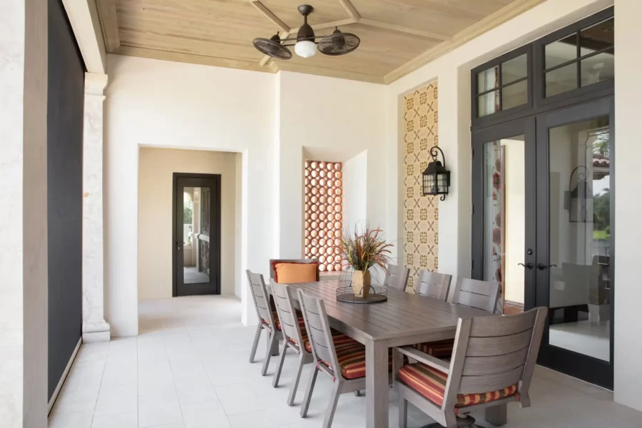 Covered Rear Terrace Dining Area with hand-painted tile accent wall and clay pipe opening